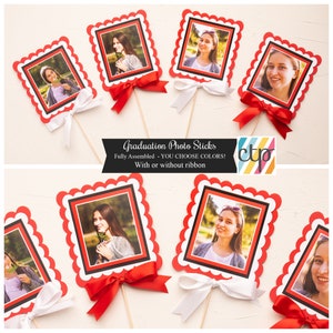 May include: Graduation photo sticks with red and white scalloped frames, red and white ribbons, and wooden sticks. The text "Graduation Photo Sticks" is printed on the image. The text "Fully Assembled - YOU CHOOSE COLORS!" is printed on the image. The text "With or without ribbon" is printed on the image.