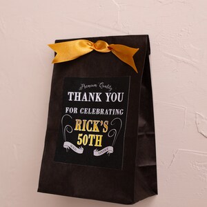 May include: Black paper gift bag with a gold ribbon and a thank you tag that says "Premium Quality Thank You for Celebrating Rick's 50th Aged Vintage".