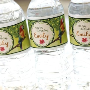May include: Three clear plastic water bottles with green, white, and orange labels. The labels feature a tropical design with a parrot and the text "Happy Birthday Emily".