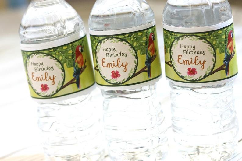 May include: Three clear plastic water bottles with green, white, and orange labels. The labels feature a tropical design with a parrot and the text "Happy Birthday Emily".