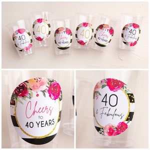 May include: Set of six clear plastic cups with black and white striped and floral patterned round stickers. The stickers feature the text "Cheers to 40 Years" and "40 & Fabulous".