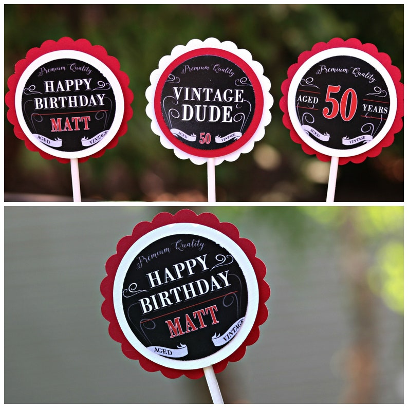 May include: Four red and white cupcake toppers with black text. The toppers say "Premium Quality", "Happy Birthday Matt", "Vintage Dude", and "Aged 50 Years".