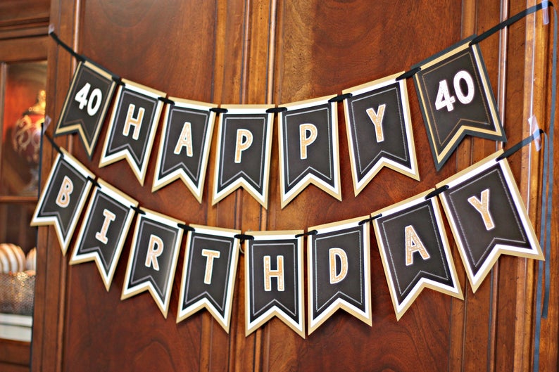 May include: Black and gold banner with the text "40 Happy Birthday" in gold letters on black flags.
