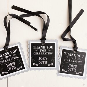 May include: Three black and white thank you tags with scalloped edges and black ribbon. The tags say "Thank you for celebrating Joe's 50th".
