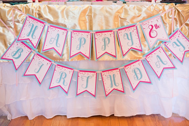 May include: A pink and blue banner with the words "Happy 8th Birthday" in a cursive font. The banner is decorated with white glitter.