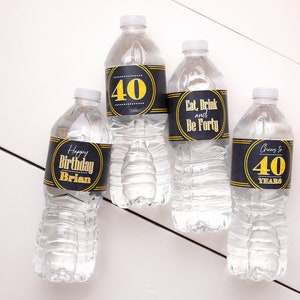 May include: Four clear plastic water bottles with black and gold labels. The labels have different text, including "Happy Birthday Brian", "40", "Eat, Drink and Be Forty", and "Cheers to 40 Years".