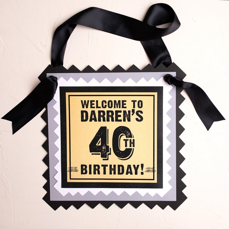 May include: Black and gold birthday banner with the text "Welcome to Darren's 40th Birthday!"
