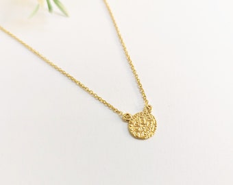 Tiny disc of Phaistos necklace in k14 gold.