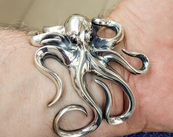 Silver octopus cuff bracelet with adjustable tentacles and garnet gemstone eyes, ocean lover gift