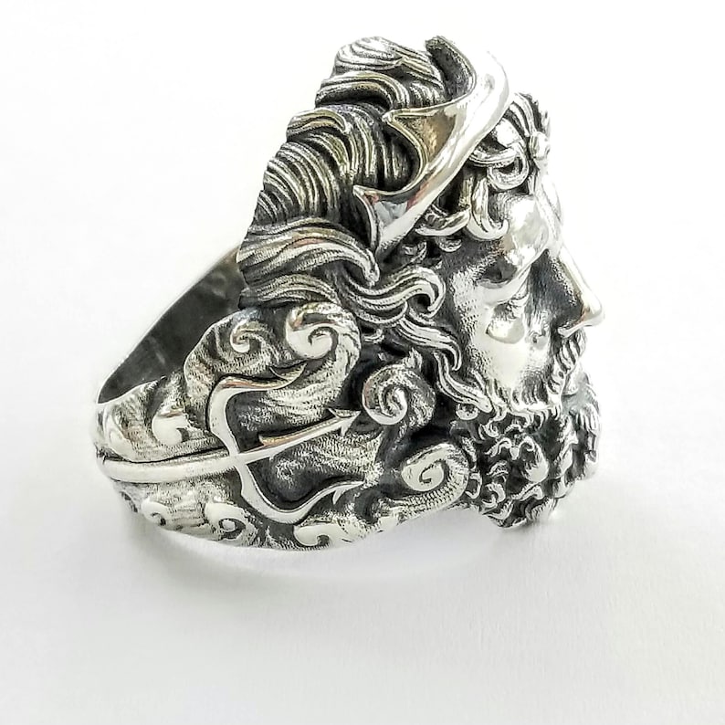 Silver ring depicting the ancient Greek God, Poseidon and his trident. Silver Neptune ring. The ring is handmade in sterling silver and is available in all sizes. Poseidon was the Greek God of the sea