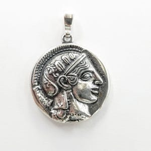 Athena the Goddess replica coin in sterling silver 925. A silver coin pendant with Goddess Athena on one side and Athena's owl (with wings open) on the other.