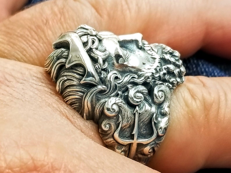 Silver ring depicting the ancient Greek God, Poseidon and his trident. Silver Neptune ring. The ring is handmade in sterling silver and is available in all sizes. Poseidon was the Greek God of the sea