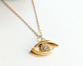 14K gold eye necklace with zirconia gemstones and stackable gold chain.
