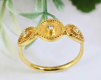 Elegant 18k Gold, Diamond Ring  with granulated bezels and geometric themes.
