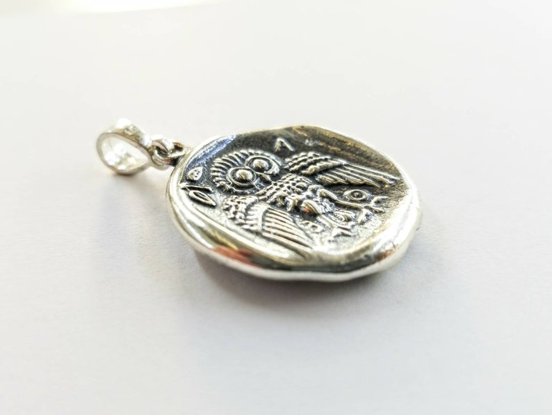 Athena the Goddess replica coin in sterling silver 925. A silver coin pendant with Goddess Athena on one side and Athena owl (with wings open) on the other.