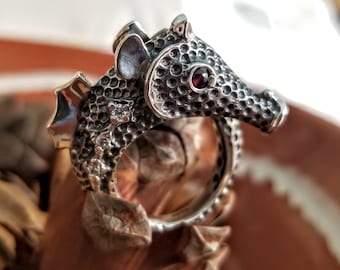 Sterling silver seahorse ring with black textured finish, cubic zirconia inlays, and garnet eyes, adjustable marine-life ring