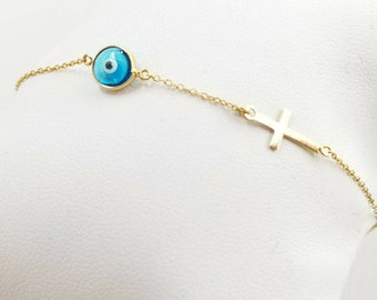 Evil eye  bracelet in solid k14 gold with gold cross.