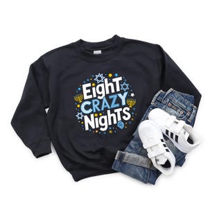 May include: Black sweatshirt with a blue and yellow design that says "Eight Crazy Nights".