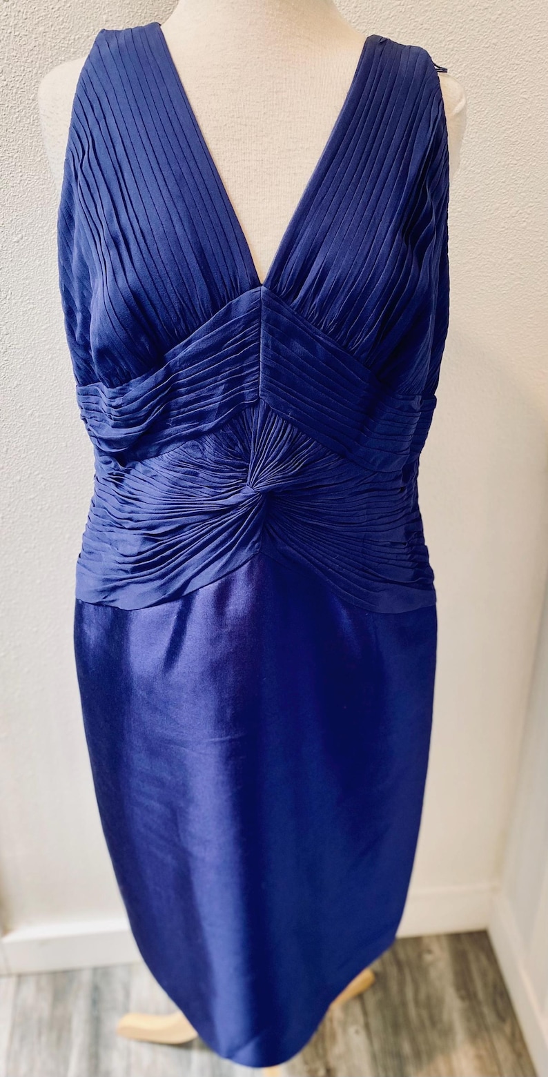 May include: A sleeveless royal blue dress with a pleated bodice and a fitted skirt.