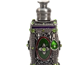May include: A silver perfume bottle with a clear glass stopper. The bottle is decorated with green and purple enamel and green rhinestones. The bottle has a small green charm hanging from it.