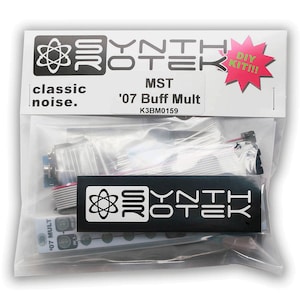 May include: A transparent plastic bag containing electronic components. The bag features a white label with the text "YNTH TEK" and "MST '07 Buff Mult". A red starburst sticker reads "DIY KIT!!!". The words "classic noise" are also visible.