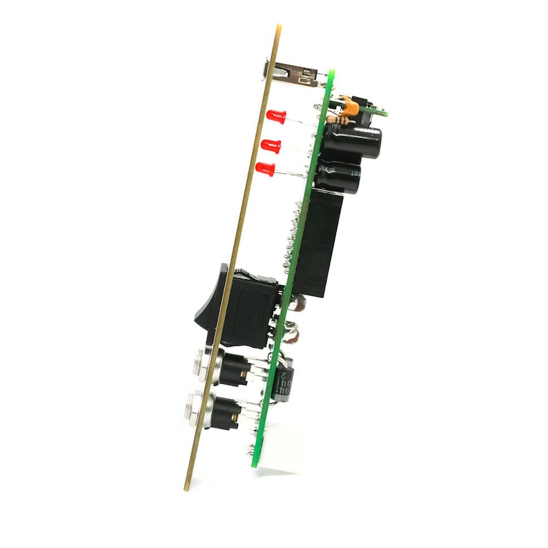 May include: A circuit board with a gold-colored edge, featuring a black switch, red LED lights, and various electronic components. The board is green and has several connectors and capacitors.