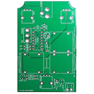 May include: A green circuit board with various electronic components, including resistors, capacitors, and an integrated circuit. The board has labels for "POWER", "OUT", "CU IN", "J3", "J2", "UR1", "UR2", "UR3", "LM556", "C3", "C5", "P1", "R4", "10K", "10uF", "01 1N4148", "VOLUME", and "HARDCH-001-APC-3.1".