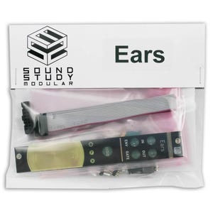 May include: A clear plastic bag containing electronic components. The bag has a white header with the word "Ears" printed in black. The bag contains a black circuit board with green and white text and several buttons, a grey ribbon cable, and other small components.