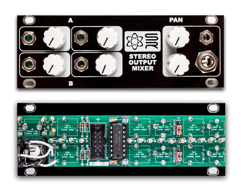 May include: A black and green circuit board with a black box on top. The box has knobs and jacks and says "Stereo Output Mixer".