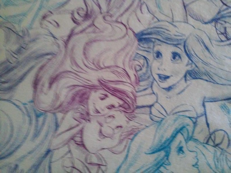May include: A drawing of two mermaids with long flowing hair. One mermaid has purple hair and the other has blue hair. The mermaids are drawn in a whimsical style with soft lines and shading.