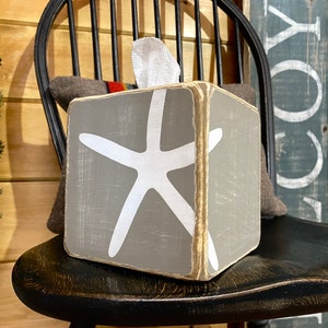 Coastal starfish tissue box cover with distressed wood finish inspired by salt air and sandy beaches, ocean and beach house decor perfect for coastal cottages, lake houses, vacation rentals, and relaxed seaside bathrooms, rustic beach style