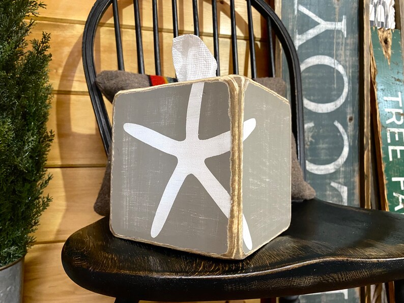 Coastal starfish tissue box cover with distressed wood finish inspired by salt air and sandy beaches, ocean and beach house decor perfect for coastal cottages, lake houses, vacation rentals, and relaxed seaside bathrooms, rustic beach style