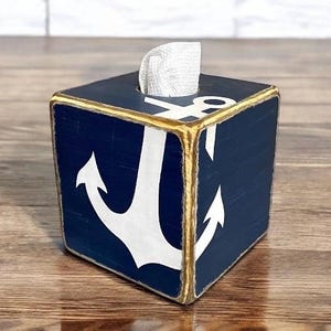 Coastal Anchor Tissue Box Covers styled in a nautical-themed coastal living space, featuring hand-painted anchor designs for beach cottages, vacation homes, seaside cabins, or short-term rental décor, adding rustic coastal charm to bedrooms, bathrooms, or living areas