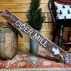 Rustic Cider Mill wood sign displayed in a farmhouse kitchen, bringing the warmth of apple orchard traditions, fall harvest, country living, and vintage farmhouse decor into the home