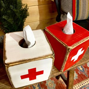 Top view of rustic First Aid wood tissue box cover for ski cabin décor, lodge bathrooms, beach houses, cabins, and guest rooms. Vintage first aid-inspired design with handcrafted wood construction adds functional and decorative charm.