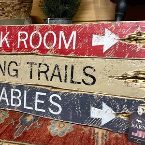 Close-up of hand-painted lettering and textured wood on the Tack Room Equestrian Sign Set, highlighting rustic Western charm, barn and tack room décor, and horse-themed style. Perfect for cabins, ranch homes, lodges, stables, and vacation rentals, showcasing authentic handcrafted detail and hand-distressed wood finish
