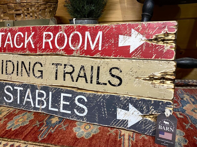 Close-up of hand-painted lettering and textured wood on the Tack Room Equestrian Sign Set, highlighting rustic Western charm, barn and tack room décor, and horse-themed style. Perfect for cabins, ranch homes, lodges, stables, and vacation rentals, showcasing authentic handcrafted detail and hand-distressed wood finish