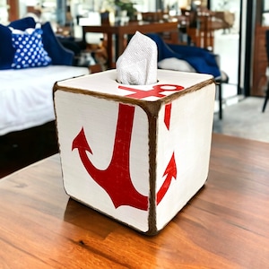 Coastal Anchor Tissue Box Cover styled in a beach cottage or vacation home, featuring hand-painted nautical anchor design for beach cottages, coastal vacation homes, nautical interiors, or seaside cabins, perfect for bedrooms, bathrooms, or living spaces