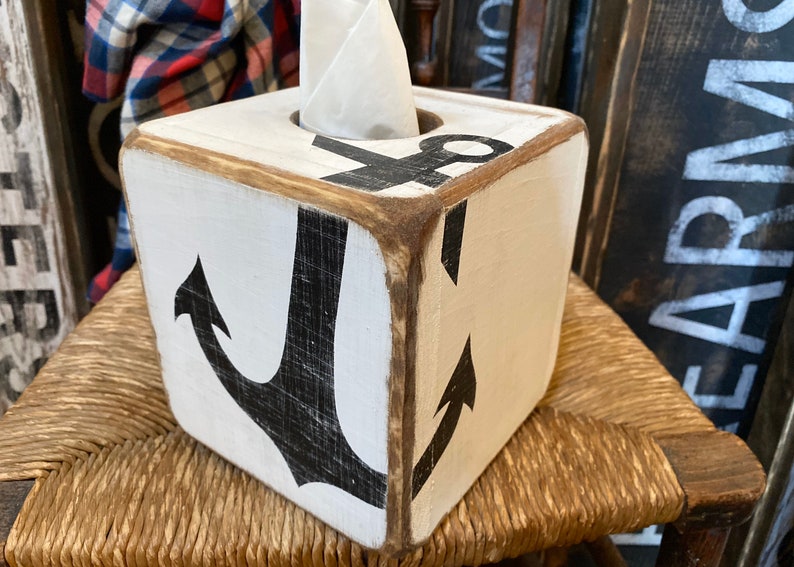 Anchor Tissue Box Cover displayed on a coastal shelf in a seaside vacation rental, showing hand-painted nautical anchor design for beach cottages, coastal homes, nautical décor, or short-term rental interiors, perfect for bedrooms, bathrooms, or living areas