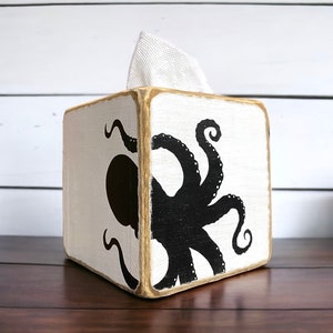 Handcrafted octopus wood tissue box cover for coastal beach houses, nautical rooms, and ocean-inspired décor. Lightly distressed for a rustic, weathered finish, ideal for bathrooms, living rooms, lake houses, or coastal retreats. Unique marine-themed accent adds charm and personality to any space, handmade in Maine