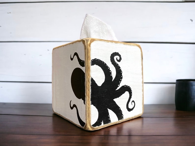 Handcrafted octopus wood tissue box cover for coastal beach houses, nautical rooms, and ocean-inspired décor. Lightly distressed for a rustic, weathered finish, ideal for bathrooms, living rooms, lake houses, or coastal retreats. Unique marine-themed accent adds charm and personality to any space, handmade in Maine