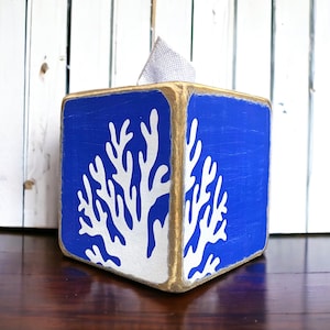 Coastal Coral Tissue Box Cover, Hand-Painted Wood, Beach House and Ocean-inspired for coastal cottages, beach houses, lake homes, or vacation rentals. Lightly distressed for a weathered, nautical look, perfect for bathrooms, living rooms, or as a thoughtful gift for ocean lovers. Handmade in Maine, adding timeless coastal charm and seaside style to any room.
