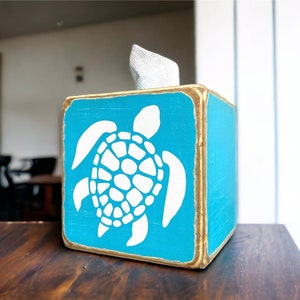 Coastal Sea Turtle Tissue Box Cover, handcrafted from rustic wood and lightly distressed for beach house, coastal cottage, or ocean-inspired bathroom décor. Perfect for cabins, vacation rentals, or seaside homes, this Maine-made tissue box adds nautical charm and weathered coastal character to any room