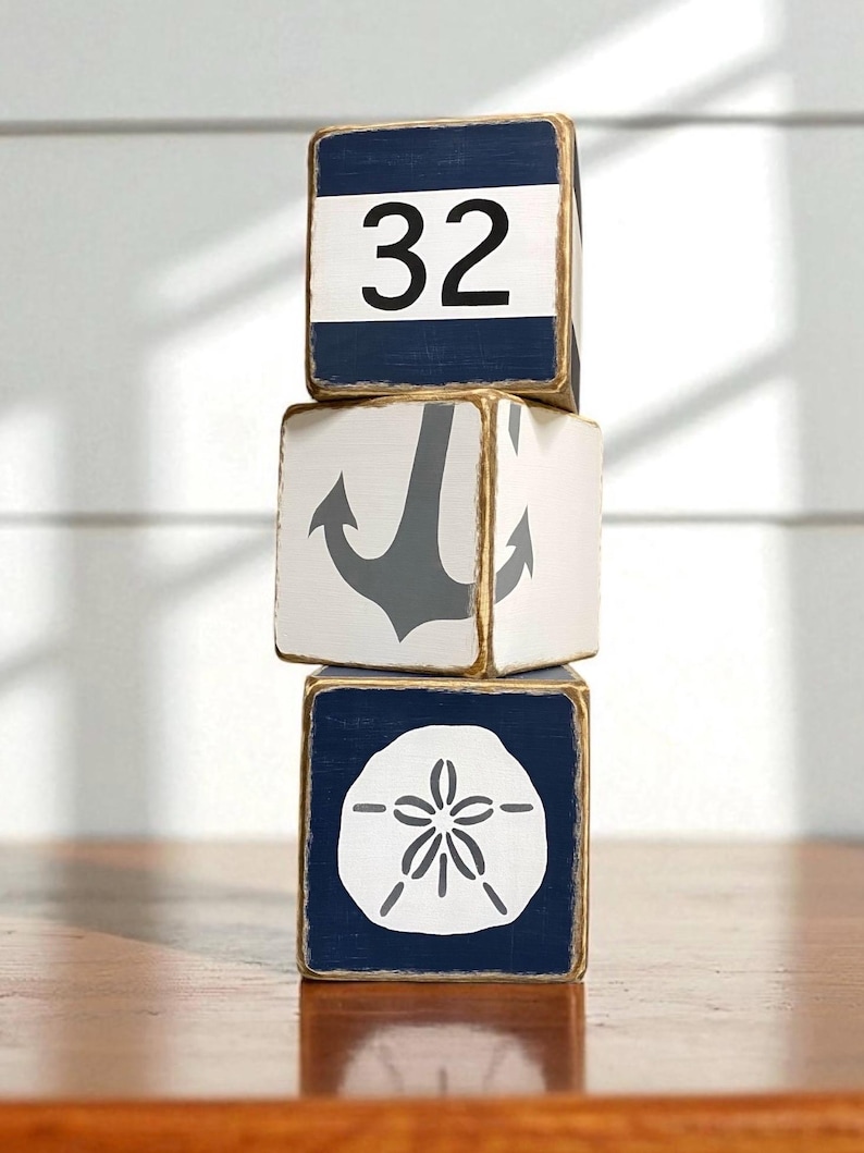 Multiple Coastal Anchor Tissue Box Covers grouped together on a coastal shelf, showing consistent hand-painted nautical anchor designs for beach cottages, vacation homes, seaside cabins, or short-term rentals, perfect for coordinated bedrooms, bathrooms, or living spaces