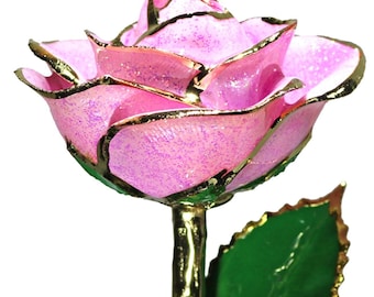May include: A single pink rose with gold-trimmed petals and leaves. The rose is preserved and has a gold-plated stem.