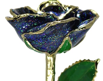 May include: A single, preserved rose with a dark blue glitter finish and gold-trimmed edges. The rose is on a gold-trimmed stem with green leaves.