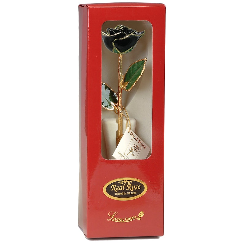 May include: A single black rose dipped in 24k gold, presented in a red box with a gold label that reads "Real Rose Dipped in 24k Gold" and "Living Gold".