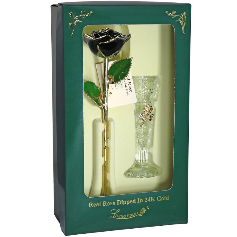 May include: A single black rose dipped in 24K gold, displayed in a clear glass vase with a gold trim. The rose and vase are presented in a green box with the text "Real Rose Dipped In 24K Gold" and "Living Gold&reg;".