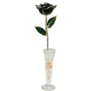 May include: A single black rose with gold trim and green leaves is displayed in a clear glass vase with a gold rose design.