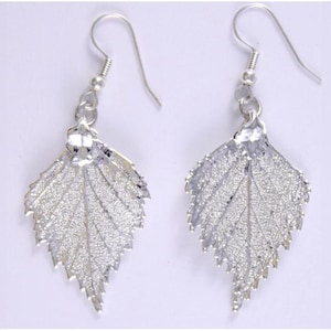 May include: A pair of silver leaf earrings. Each earring has a detailed leaf design with visible veins and a textured surface. The earrings have a hook closure and are designed for pierced ears. The leaves are approximately 4 cm long.